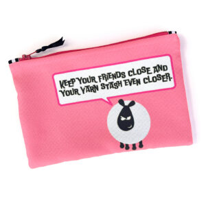 A pink zippered pouch with a humorous speech bubble saying "Keep your friends close and your yarn stash even closer" with a grumpy sheep icon.