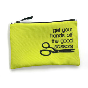 A neon green zippered pouch with the phrase "get your hands off the good scissors" in black text alongside a scissors icon.