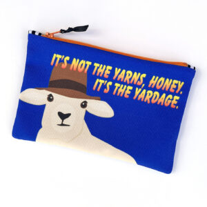 A blue zippered pouch featuring a cartoon sheep wearing a hat with the text "It's not the yarns, honey, it's the yardage."