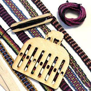 A wooden weaving loom with colorful woven bands, showcasing intricate patterns and designs.