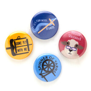 A collection of four colorful pin badges with knitting and sheep-themed designs.